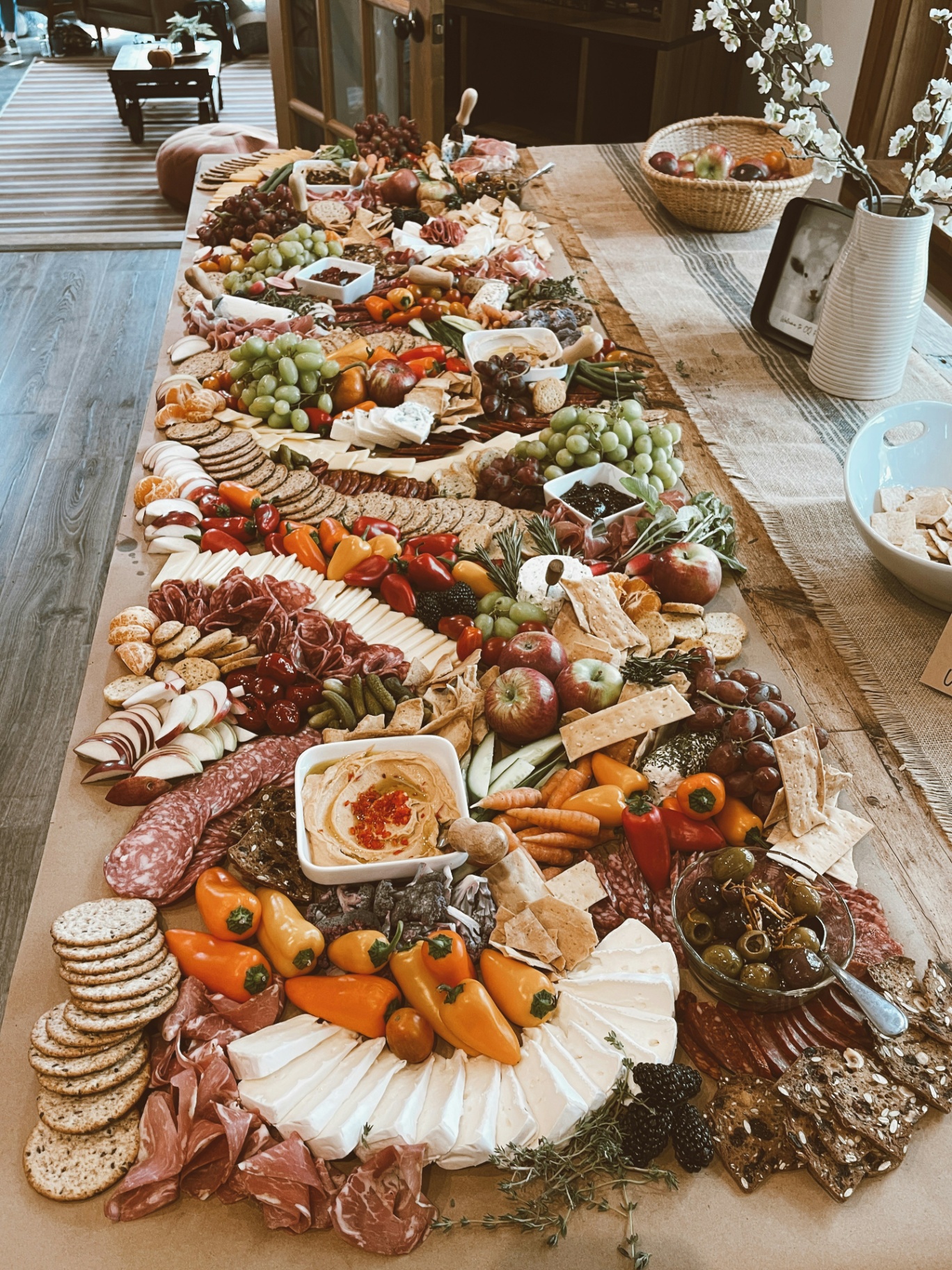 A grand grazing table in a barn lit by string lights.